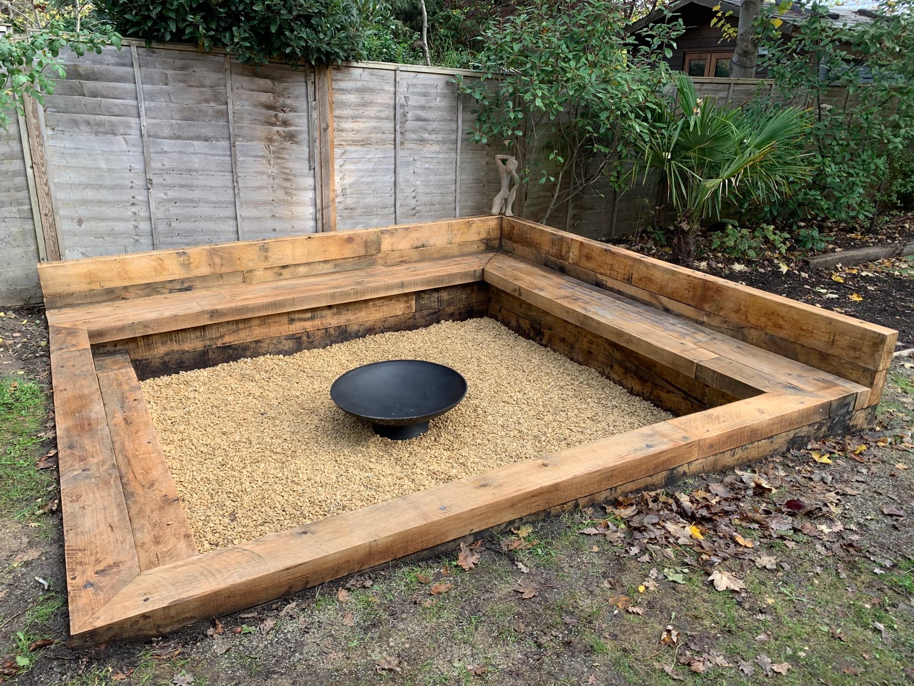 Garden beds, a circular fire pit and lawn