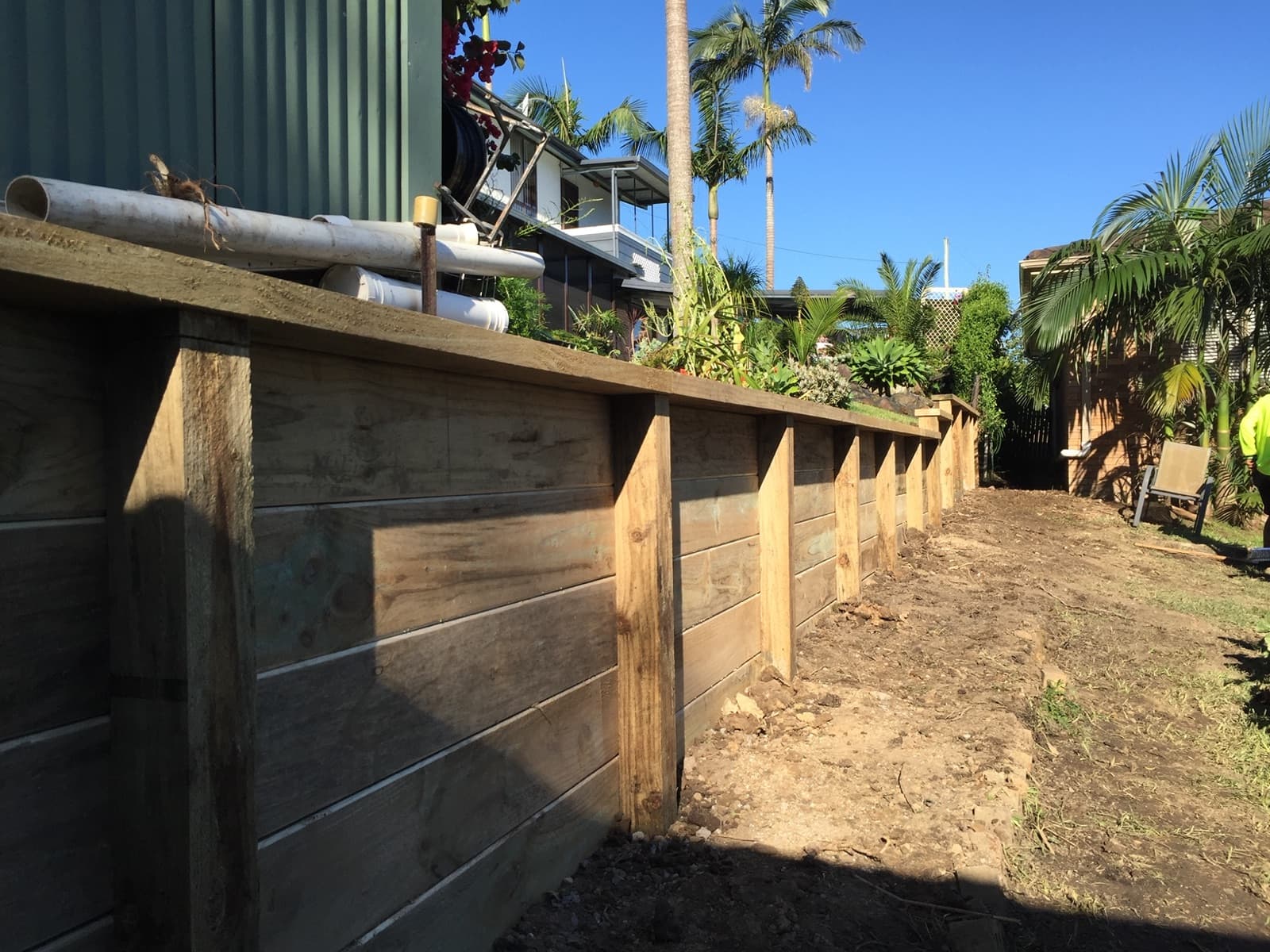 Timber deck and retaining over a backyard pond