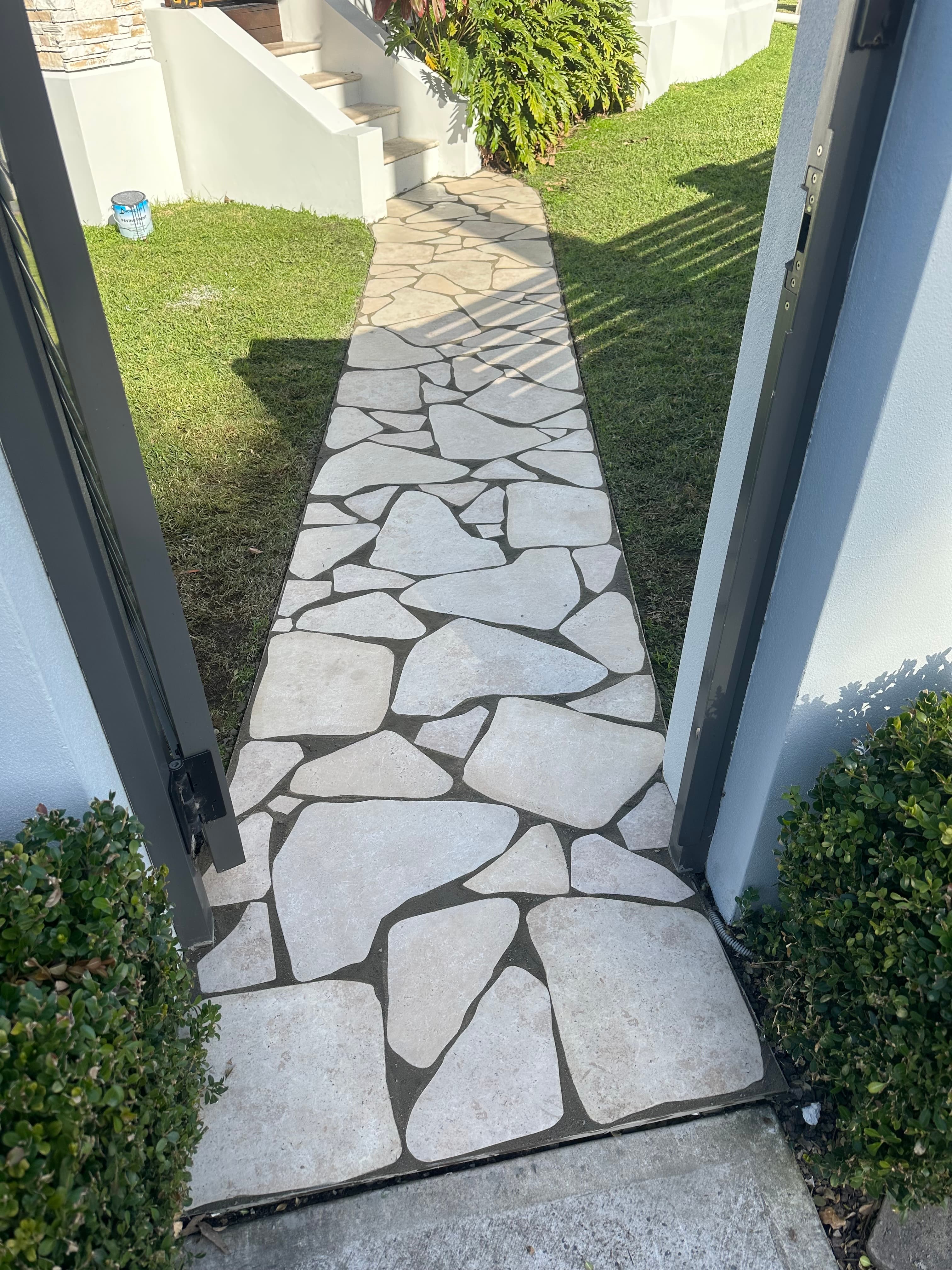 French pattern Sandstone-paved area with a timber storage shed and living roof
